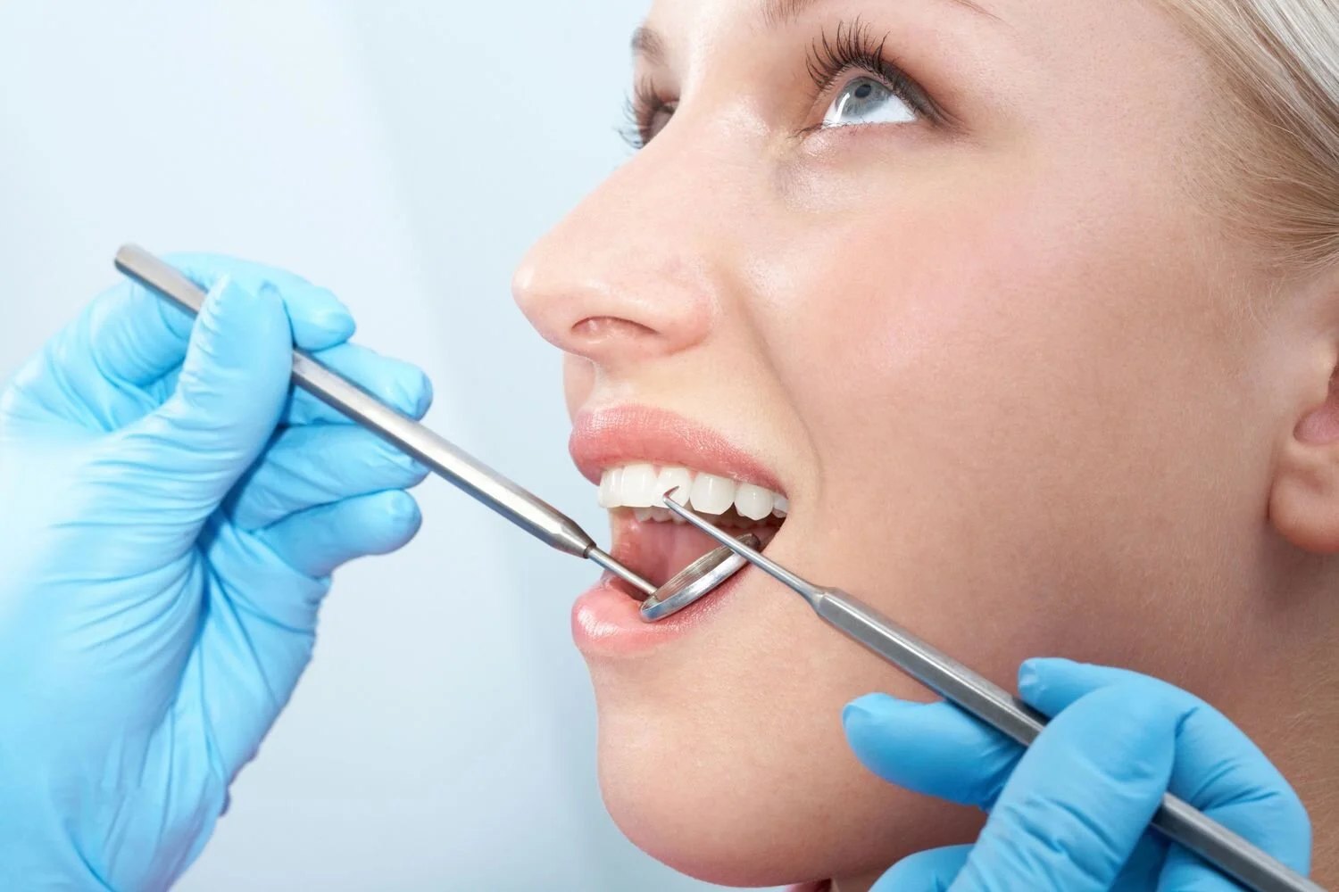 A close view of a dental examination with a mirror